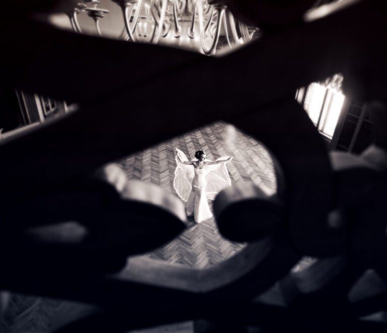 Beauty bride in bridal gown with lace veil indoors. Beautiful model girl in a white wedding dress. Female portrait of cute lady. Woman with hairstyle