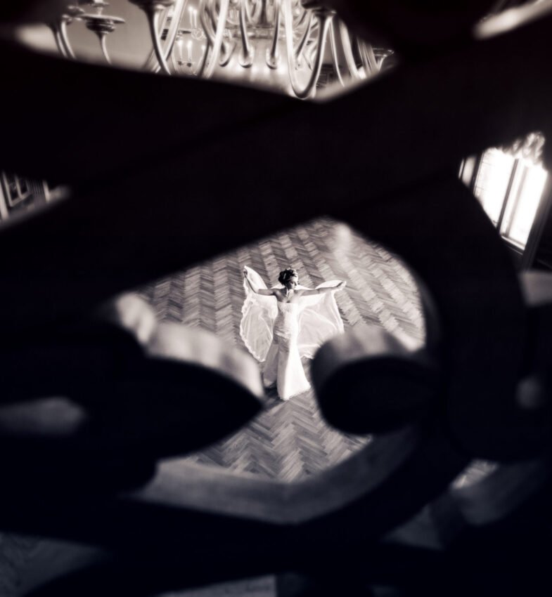 Beauty bride in bridal gown with lace veil indoors. Beautiful model girl in a white wedding dress. Female portrait of cute lady. Woman with hairstyle